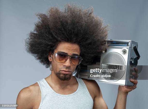 man with big afro hair  listening to funky music on ghetto blaster - portable radio stock pictures, royalty-free photos & images
