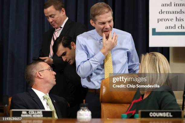House Judiciary Committee member Rep. Jim Jordan talks with ranking member Rep. Doug Collins and minority counsel Ashley Hury Callen during a...