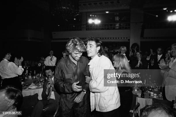 English singer-songwriters George Michael and Andrew Ridgeley of pop duo Wham at the Ivor Novello Awards, UK, 14th March 1985.