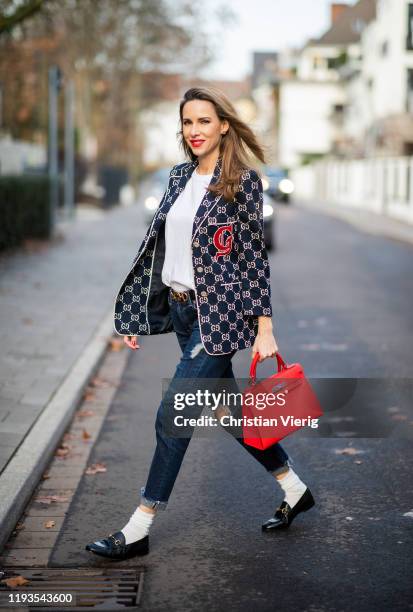 Alexandra Lapp is seen wearing dark denim blue jeans AG Jeans, white sleeveless muscle tshirt with padded shoulders The Frankie Shop, Gucci GG...