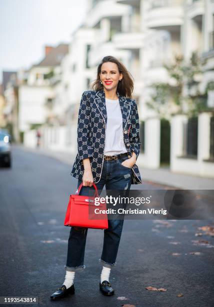 Alexandra Lapp is seen wearing dark denim blue jeans AG Jeans, white sleeveless muscle tshirt with padded shoulders The Frankie Shop, Gucci GG...