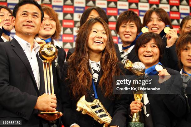 Japan team coach Norio Sasaki, Homare Sawa and Shinobu Ohno attend a press conference as the Women's World Cup winning team return home, at The...