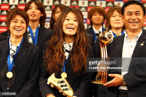 Japan team coach Norio Sasaki , Homare Sawa and Yukari Kinga attend a press conference as the Women's World Cup winning team return home, at The...