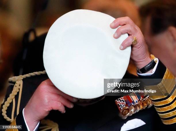 Prince Charles, Prince of Wales puts on his cap as he departs after attending a Service of Thanksgiving for the life and work of Sir Donald Gosling...