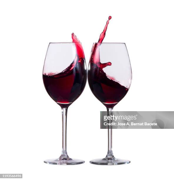 raising a toast of red wines on a white background. - champagner gläser mit flasche unscharfer hintergrund stock-fotos und bilder