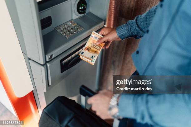 tourist withdrawing money on the atm - atm cash stock pictures, royalty-free photos & images