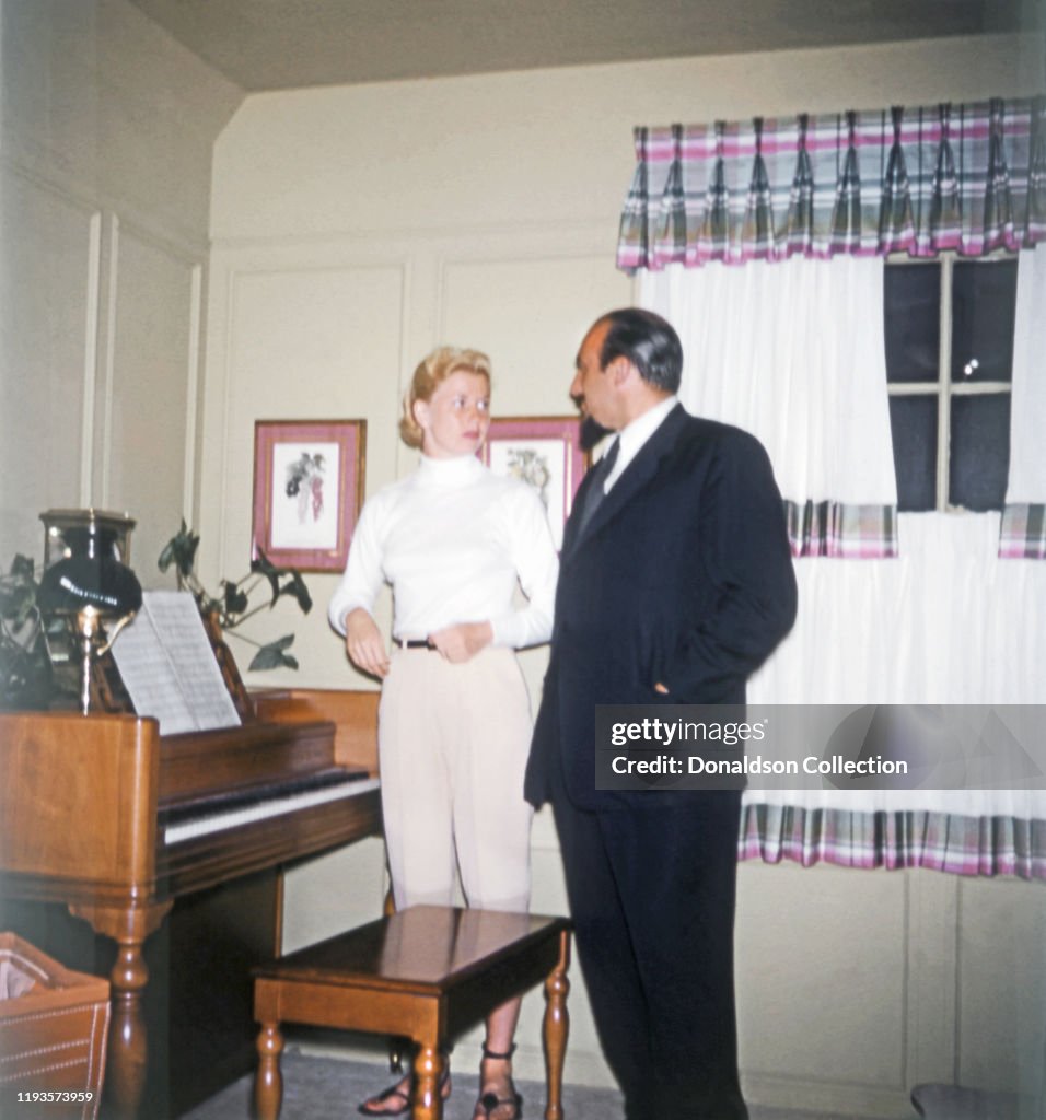 Doris Pacot Rushing Doris Day and producer Mitch Miller chat by a piano at her home in ...