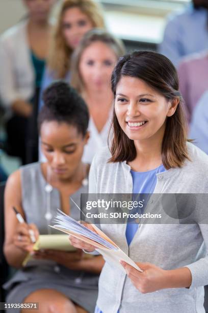 businesswoman giving presentation during seminar - diverse town hall meeting stock pictures, royalty-free photos & images