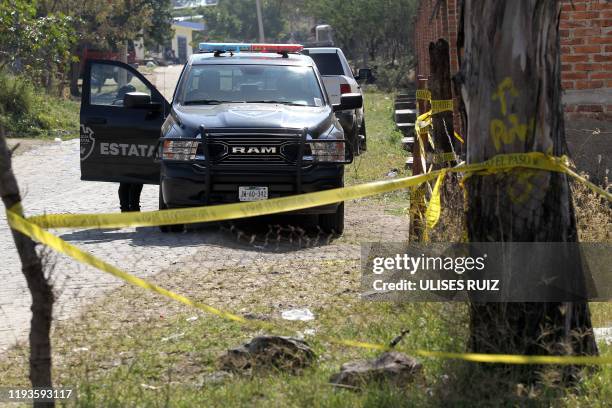 The area around a clandestine mass grave discovered at El Mirador neighbourhood in Tlajomulco de Zuniga, Jalisco State, Mexico, is cordoned-off as...