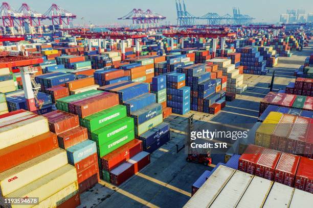 Containers are seen stacked at a port in Qingdao in China's eastern Shandong province on January 14, 2020. China's trade surplus with the United...