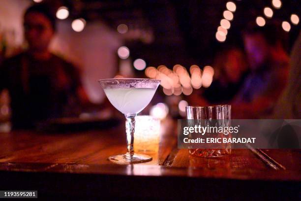 Two cocktails are seen waiting on the bar at "The Mirror" Speakeasy bar in Washington,DC on January 3, 2020. - A century after the United States...