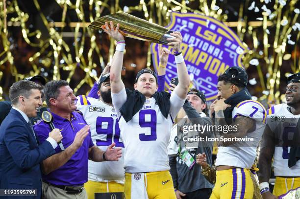 Tigers quarterback Joe Burrow hoists the trophy high after winning the CFP National Championship game between the LSU Tigers and Clemson Tigers at...