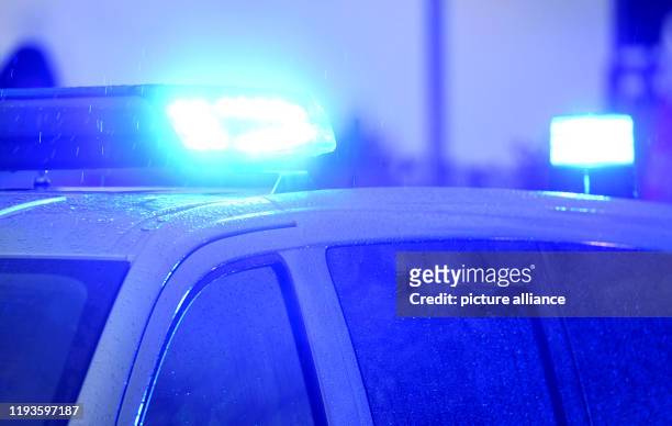 January 2020, Schleswig-Holstein, Kiel: A police car with the blue light on is on the verge of a demonstration in Kiel. Photo: Carsten Rehder/dpa