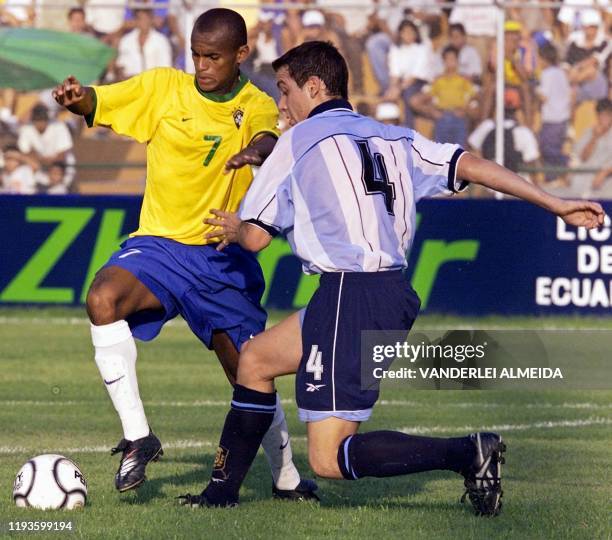 Ewerton Henrique of Brazil and Pablo De Muner of Argentina fight for the ball during a match at the South American Soccer Championships in...