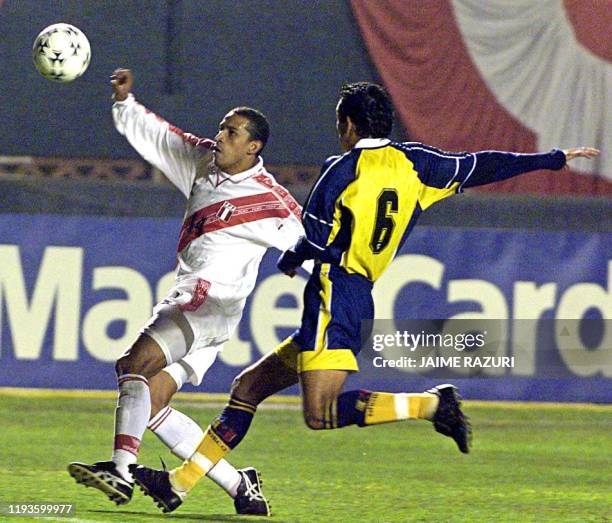 Peruvian player Jorge Soto fights for the ball with Venezuelan player Elvis Martinez during their Japan-Korea 2002 World Cup qualifying match at the...