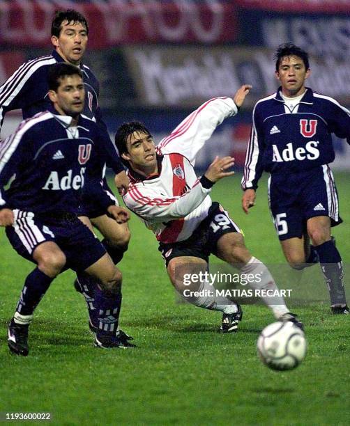 Argentina's River Plate player Martin Cardetti chases the ball with Universidad de Chile players Ronald Fuentes , Cristian Mora and David Reyes 12...