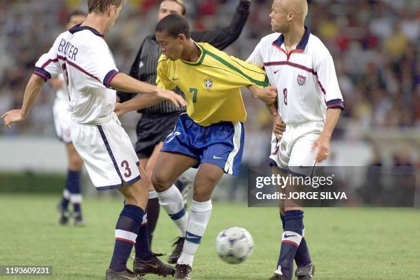 Ronaldinho of Brazil is surrounded by US players Ernie Stewart and Gregg Berhaalter during their Group B Copa FIFA Confederaciones game in...