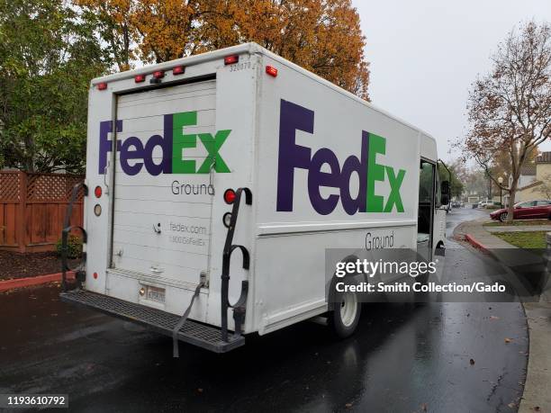 Federal Express delivery truck completing deliveries in a suburban neighborhood in San Ramon, California, December 11, 2019. The holiday season is...