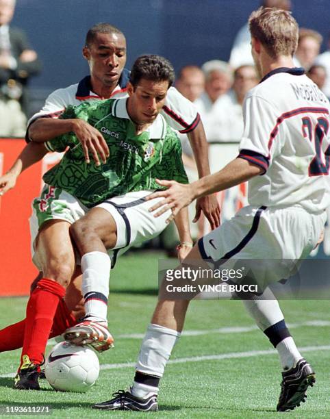Jose Manuel Abundis of Mexico fights for control of the ball with Eddie Pope and Brian McBride of Team USA during their Nike US Cup soccer match 13...