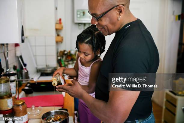 Young Girl Helping Father In The Kitchen