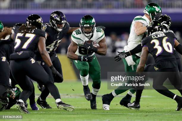 Running back Ty Montgomery of the New York Jets carries the ball aginst the defense of the Baltimore Ravens at M&T Bank Stadium on December 12, 2019...