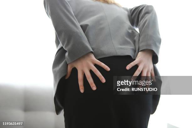 woman with pain in buttocks - woman hemorrhoids stock pictures, royalty-free photos & images