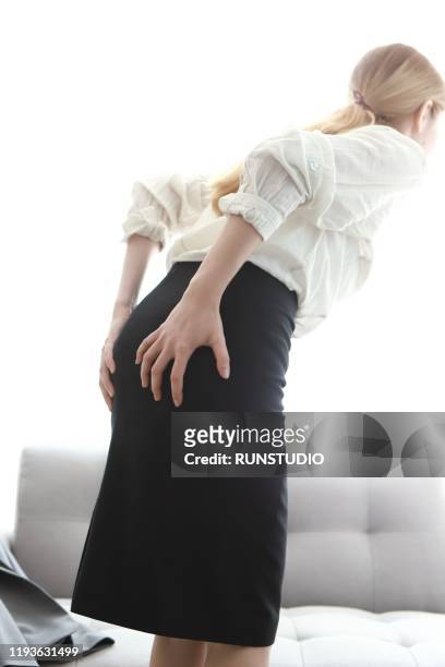 woman with pain in buttocks - woman hemorrhoids stock pictures, royalty-free photos & images