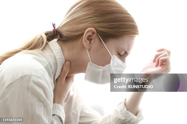 woman wearing flu mask and cough - tokyo covered by haze stockfoto's en -beelden