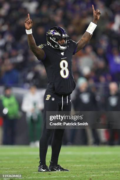 Quarterback Lamar Jackson of the Baltimore Ravens celebrates after throwing a touchdown pass to wide receiver Marquise Brown a against the New York...