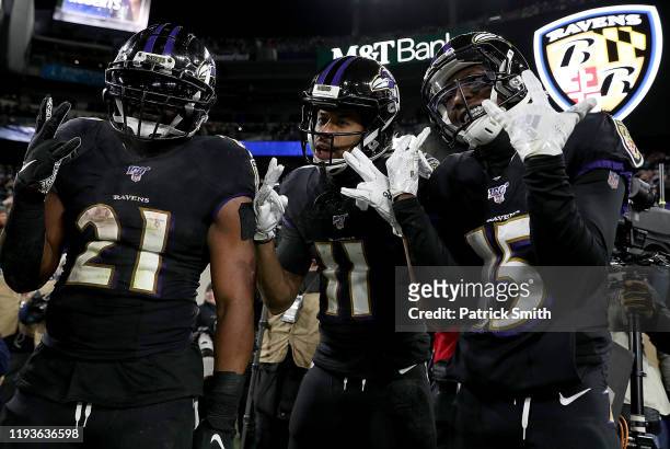 Wide receiver Seth Roberts of the Baltimore Ravens and teammates running back Mark Ingram and wide receiver Marquise Brown celebrate Roberts'...