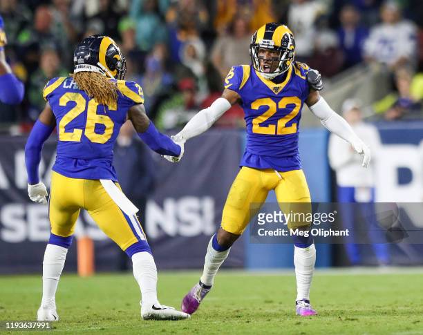 Cornerback Troy Hill of the Los Angeles Rams celebrates with defensive back Marqui Christian after catching a pass intended for wide receiver Tyler...
