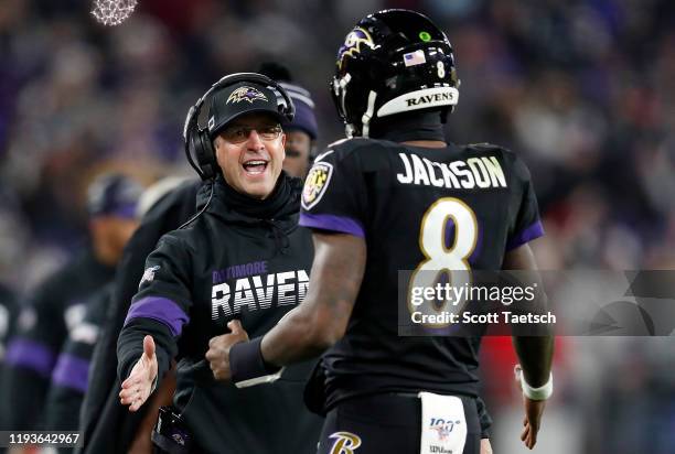 Head coach John Harbaugh of the Baltimore Ravens and quarterback Lamar Jackson celebrate a touchdown in the third quarter of the game against the New...