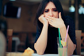 Nauseated Woman Feeling Sick at the Restaurant