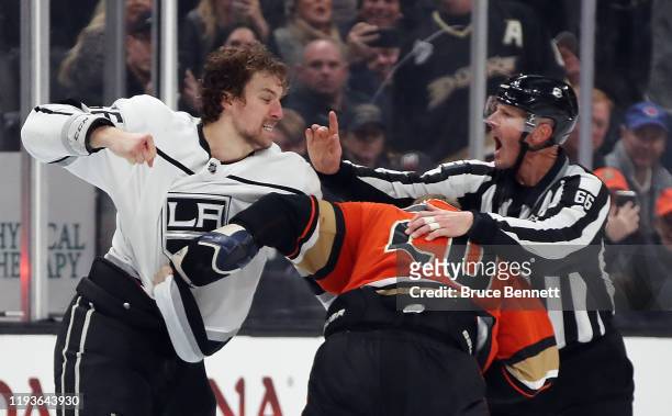 Linesman Darren Gibbs gets involved during the fight between Nicolas Deslauriers of the Anaheim Ducks and Kurtis MacDermid of the Los Angeles Kings...