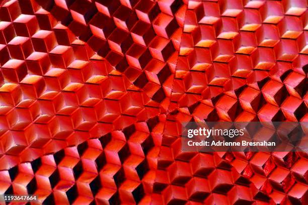 red reflector, close-up, showing isometric projection pattern - op art stock pictures, royalty-free photos & images