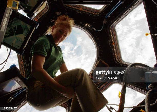 In this handout image provided by the National Aeronautics and Space Administration , NASA astronaut Sandy Magnus, STS-135 mission specialist, gets...