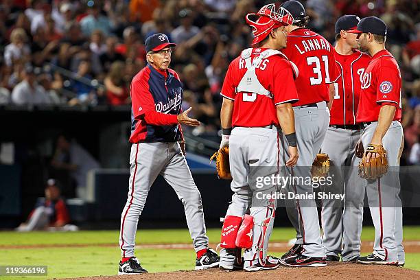 Davey Johnson of the Washington Nationals walks out to the pitcher's mound to relieve a John Lannan in the game against the Atlanta Braves on July...