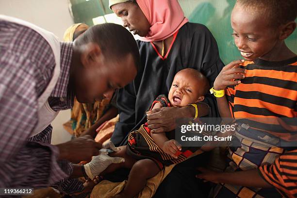 Young child is given a vaccine by Medecins Sans Frontieres in the Dagahaley refugee camp which makes up part of the giant Dadaab refugee settlement...