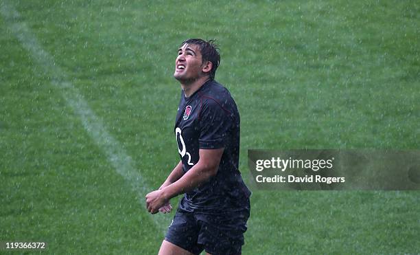 Toby Flood looks on during a heavy downpour during the England training session held at the Pennyhill Park Hotel on July 19, 2011 in Bagshot, England.
