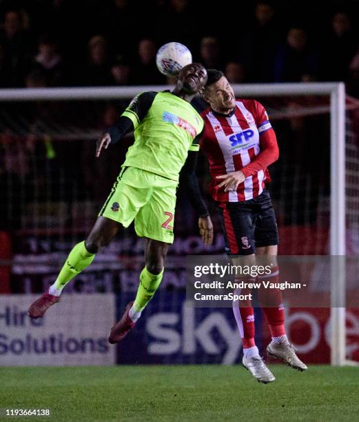 Lincoln City's Jason Shackell battles with Bolton Wanderers' Joe Dodoo during the Sky Bet League One match between Lincoln City and Bolton Wanderers...