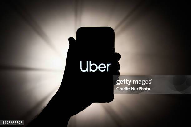 In this photo illustration, Uber logo is seen displayed on a phone screen in this illustration photo taken in Krakow, Poland on January 11, 2020.