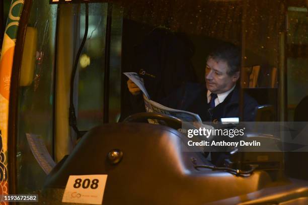 Bus driver reads a newspaper at Stalybridge Train Station after the Conservative Party won a majority in the 2019 UK General Election on December 13,...