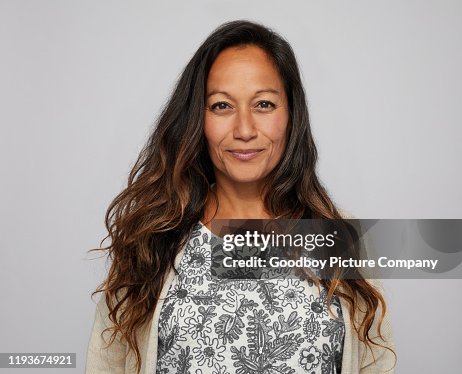 Mature woman smiling confidently in front of a gray background Mature woman smiling confidently in front of a gray background