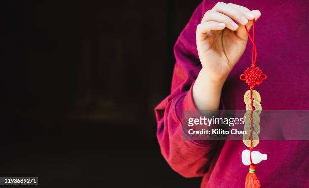 chinese new year celebration-woman holding a fengshui ornament - feng shui house stock pictures, royalty-free photos & images