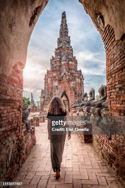 young woman exploring wat chai watthanaram temple in ayutthaya, thailand - ayuthaya stock pictures, royalty-free photos & images