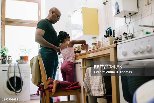 Dad Letting Young Daughter Help Out In The Kitchen