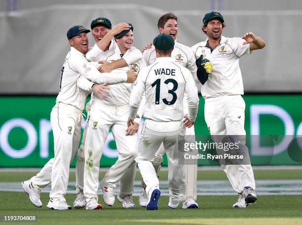 Steve Smith of Australia celebrates after taking a catch to dismiss Kane Williamson of New Zealand off the bowling of Mitchell Starc of Australia...