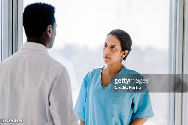healthcare professionals discussing in hospital - nurse serious stock pictures, royalty-free photos & images