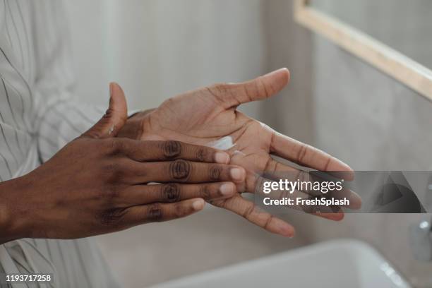 vrouw die hand crème toepast - woman washing face stockfoto's en -beelden