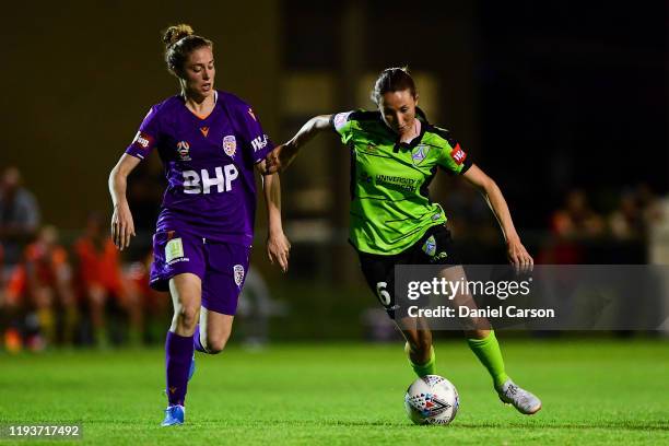 Emma Stanbury of Camberra United attempts to get past Celia Jiménez Delgado of the Perth Glory during the round five W-League match between the Perth...